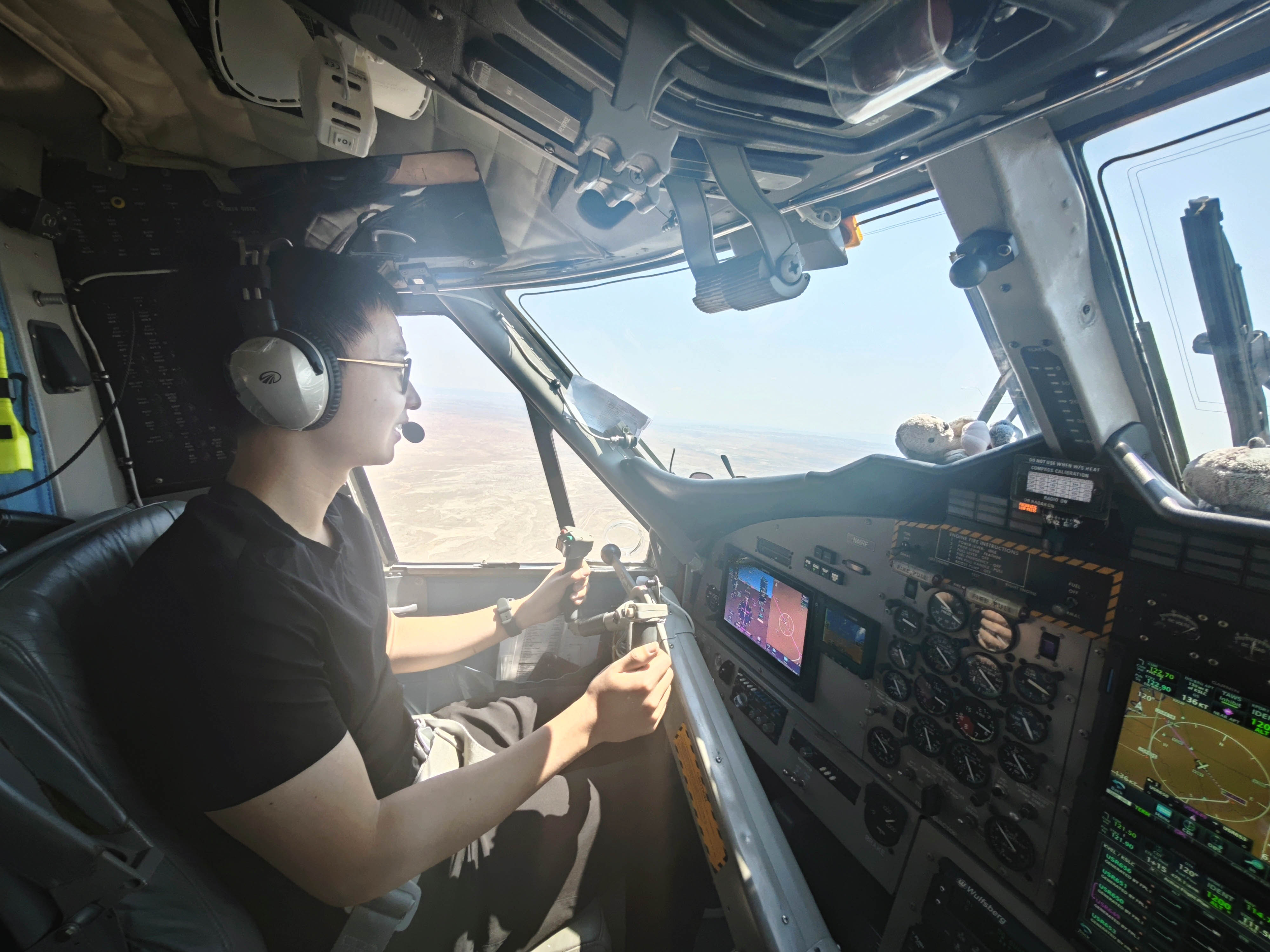 photo of a man at the controls in an aircraft cockpit