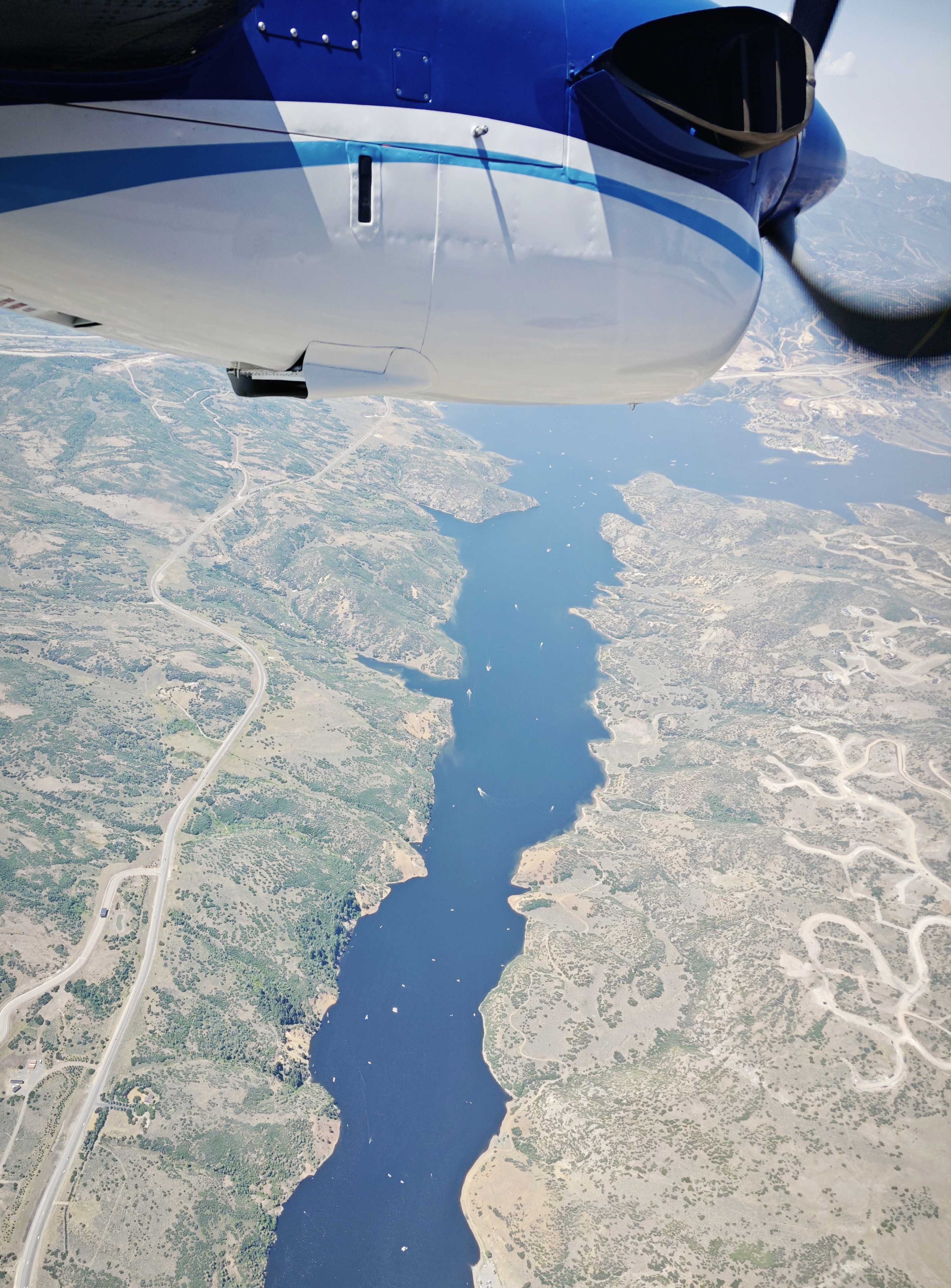 aerial view of a river, propeller from the plane captured at top of photo