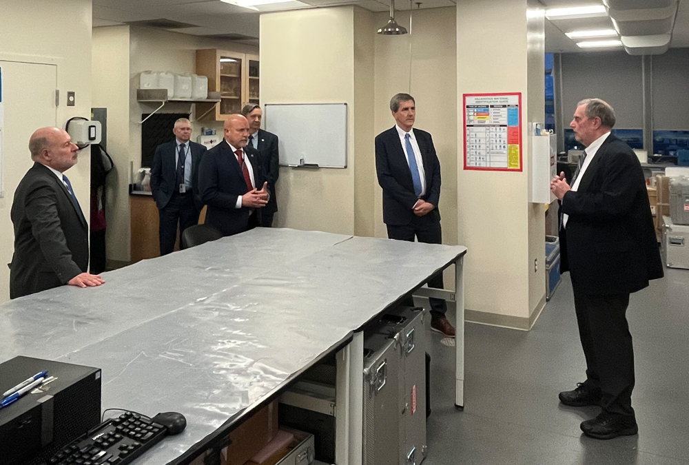 group of men in suits in an office lab space